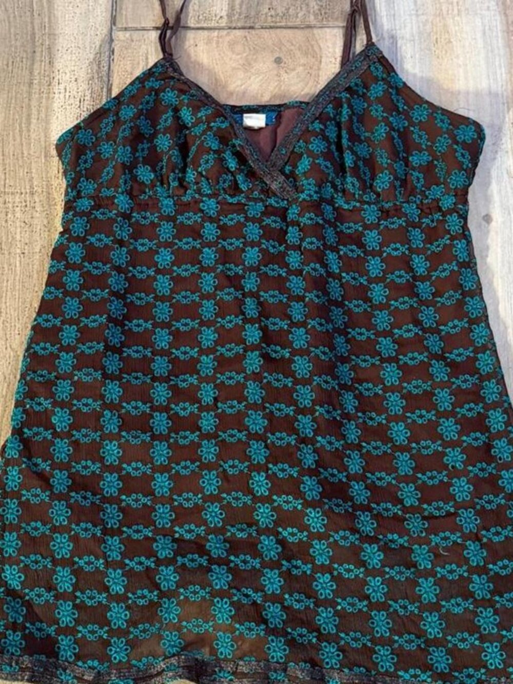 Cowgirl Up brown and teal floral babydoll tank top with a teal geometric pattern